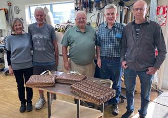 A group of people standing next to a table

Description automatically generated